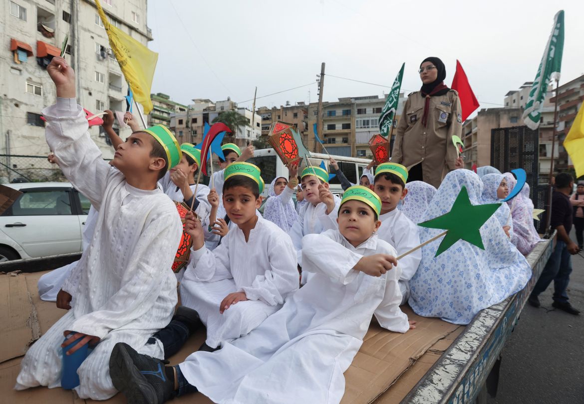 Members of Muslim Scout Association hold decorations during a rally to welcome the holy fasting month of Ramadan, in Sidon, Lebanon
