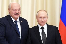 Russian President Vladimir Putin shakes hands with Belarusian President Alexander Lukashenko