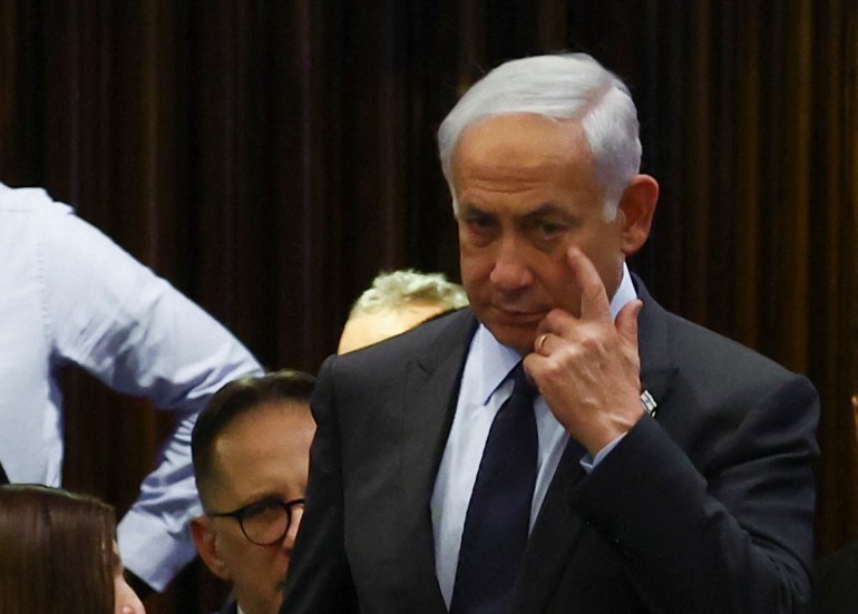 Israeli Prime Minister Benjamin Netanyahu gestures as he attends a meeting at the Knesset.