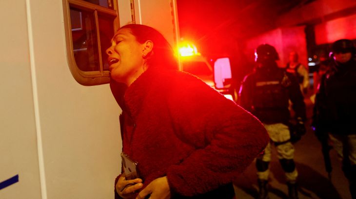 Viangly, a Venezuelan migrant, reacts outside an ambulance for her injured husband Eduard Caraballo while Mexican authorities and firefighters remove injured migrants, mostly Venezuelans, from inside the National Migration Institute (INM) building during a fire, in Ciudad Juarez, Mexico March 27, 2023