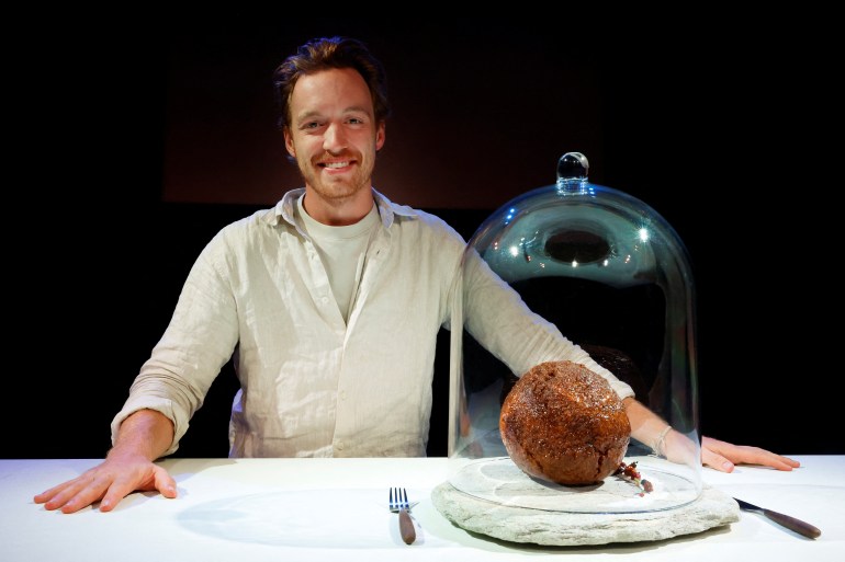 Founder of Australian cultured meat company Vow, Tim Noakesmith shows a meatball made from flesh cultivated using the DNA of an extinct woolly mammoth 
