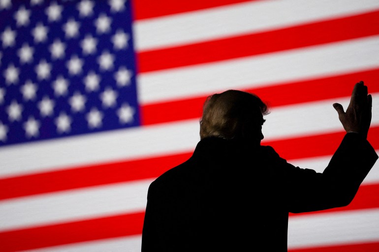 Trump in silhouette against American flag