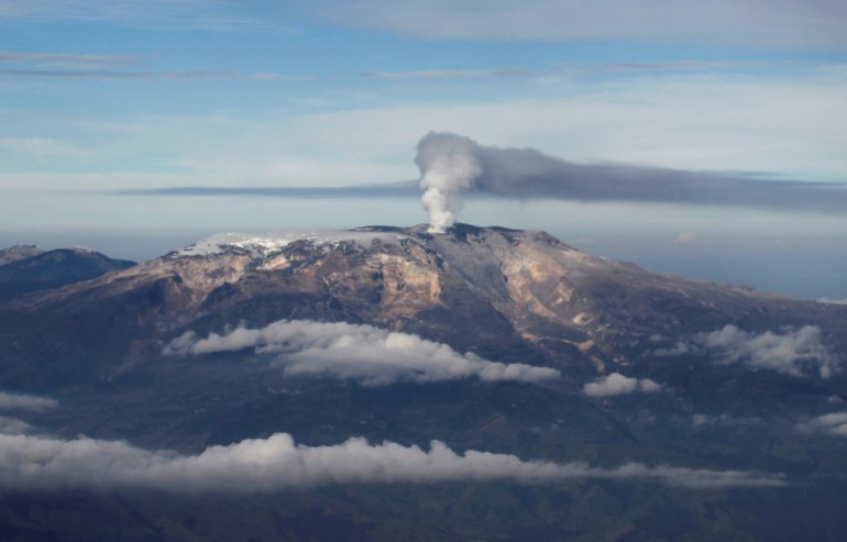 An archival photo of ash spewing from the volcano, seen from above the clouds