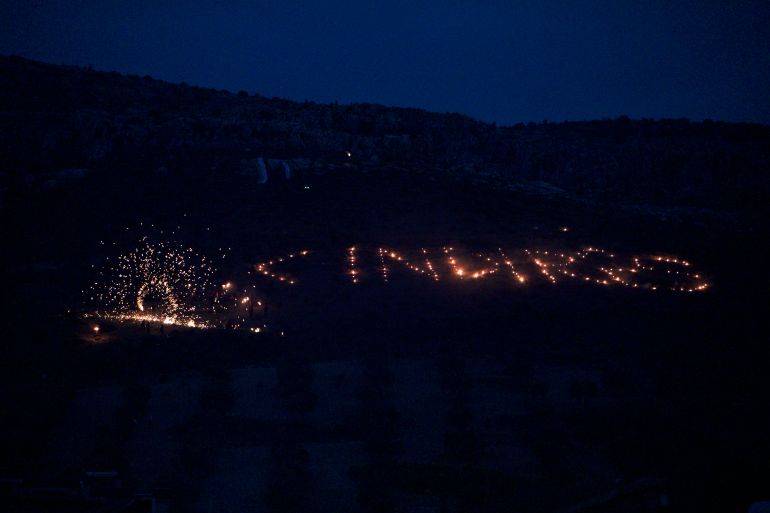 Lights in the dark spell out 'Cindires', the Kurdish spelling of Jinderes