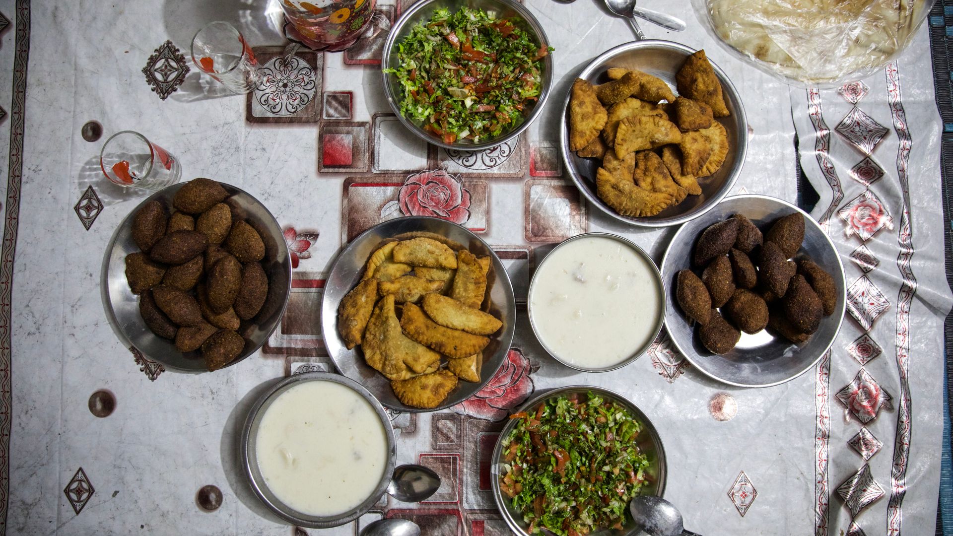 Overhead view of the food laid out on a tablecloth on the floor