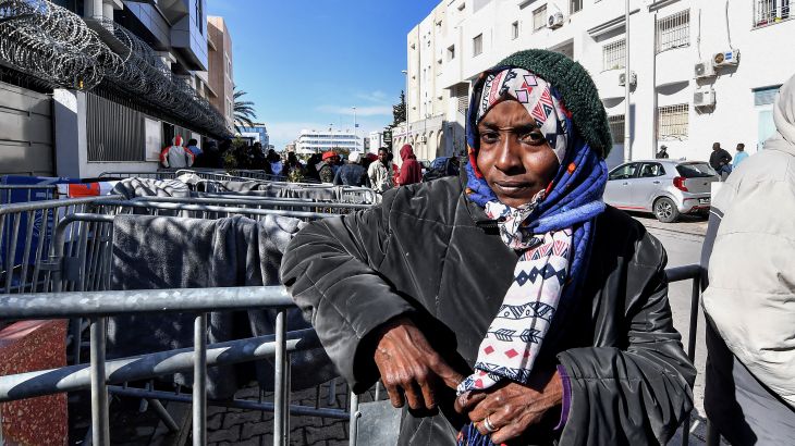 A woman looks on as she attends a gathering of sub-Saharan African migrants outside the officers of the United Nations High Commissioner for Refugees (UNHCR) in Tunis.