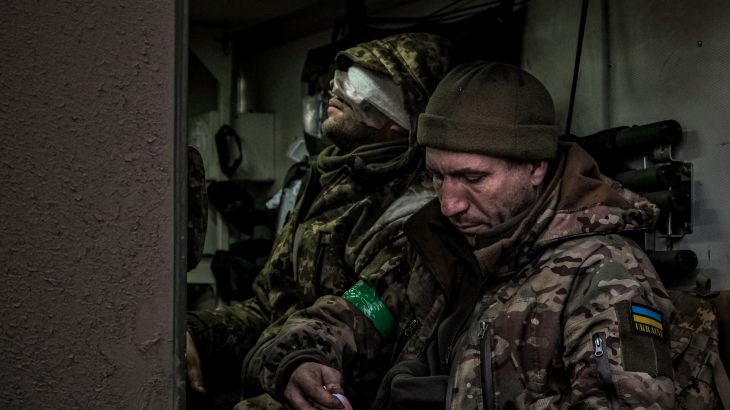 A wounded Ukrainian soldier in an armoured personnel carrier being evacuated from the front line in Bakhmut