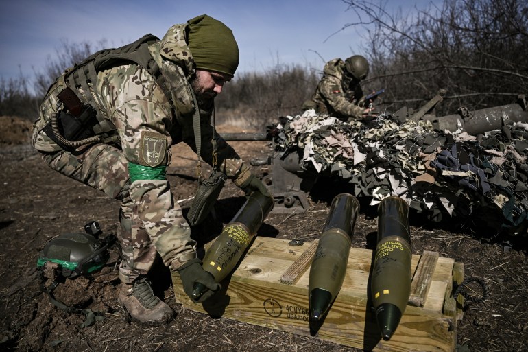 A Ukrainian serviceman prepares a 105 shell to fire at Russian possitions near Bakhmut.