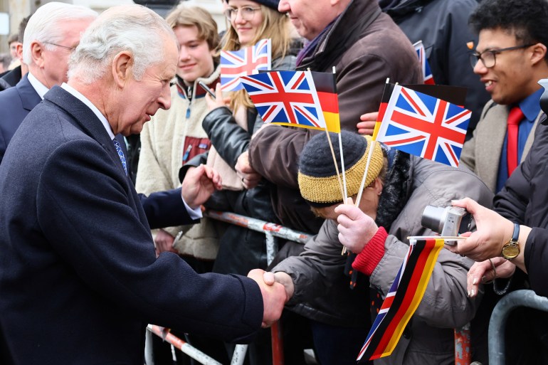 Britain's King Charles III (L) greets well-wishers following a welcome ceremony at Brandenburg Gate 