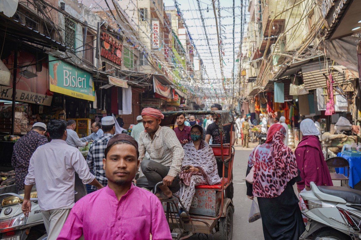 A view of the well-known market outside the Jama Masjid. The market attracts a large crowd because it connects to other historical sites in Old Delhi and offers a wide range of traditional foods and delicacies.