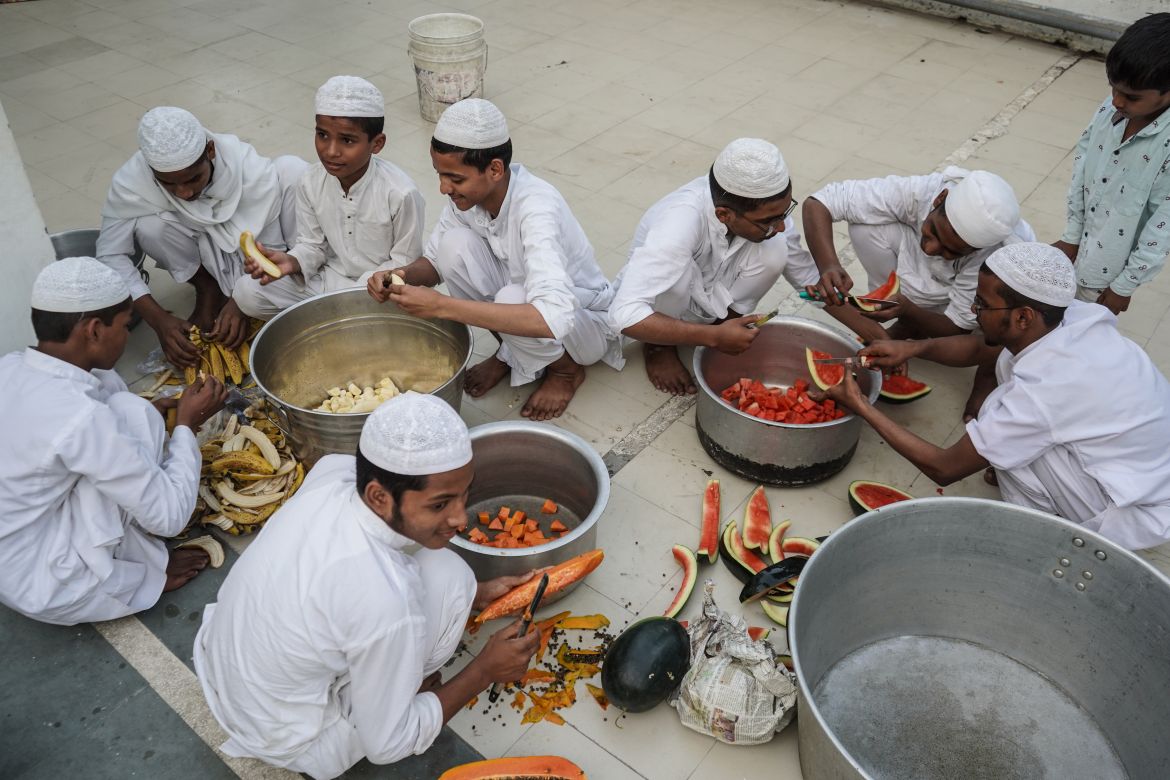 Young boys cut fruits in a mosque in New Delhi to serve them to people visiting the mosque to break their fast. During the month of Ramadan, Muslims fast from dawn to dusk.