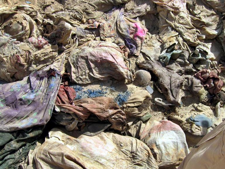 Shoes and trousers lie in mass grave site