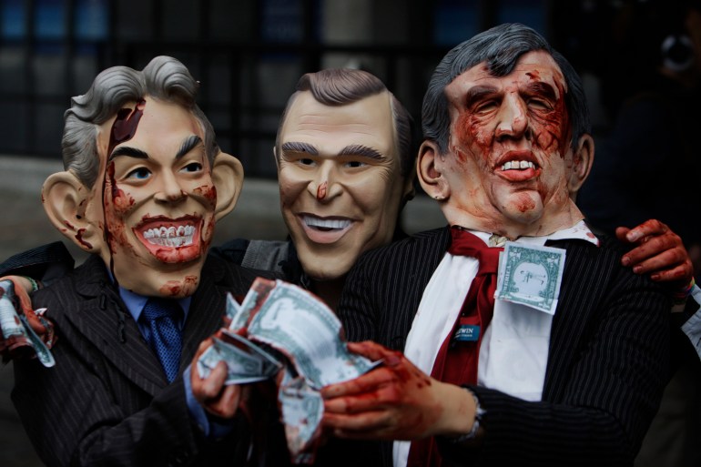 Anti-war protesters from the 'Stop the War' group, wearing rubber masks