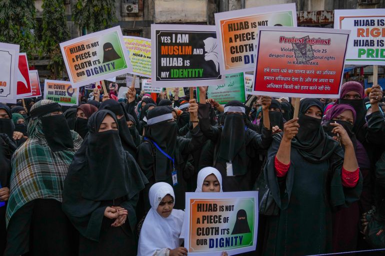 Indian Muslim women shout slogans against banning Muslim girls wearing hijab from attending classes at some schools in the southern Indian state of Karnataka during a protest in Mumbai, India, Sunday, Feb. 13, 2022. (AP Photo/Rafiq Maqbool)