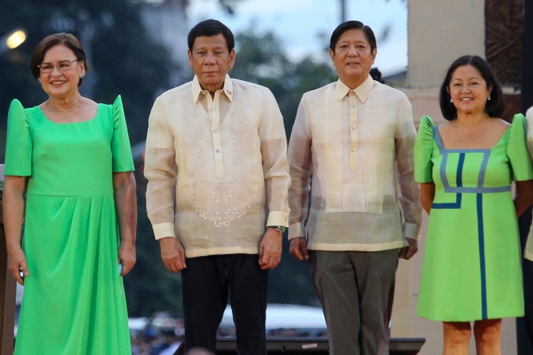 Former President Rodrigo Duterte and current President Ferdinand Marcos Jr standing side by side with their wives at the inauguration of Sara Duterte as vice president. They are wearing traditional shirts.