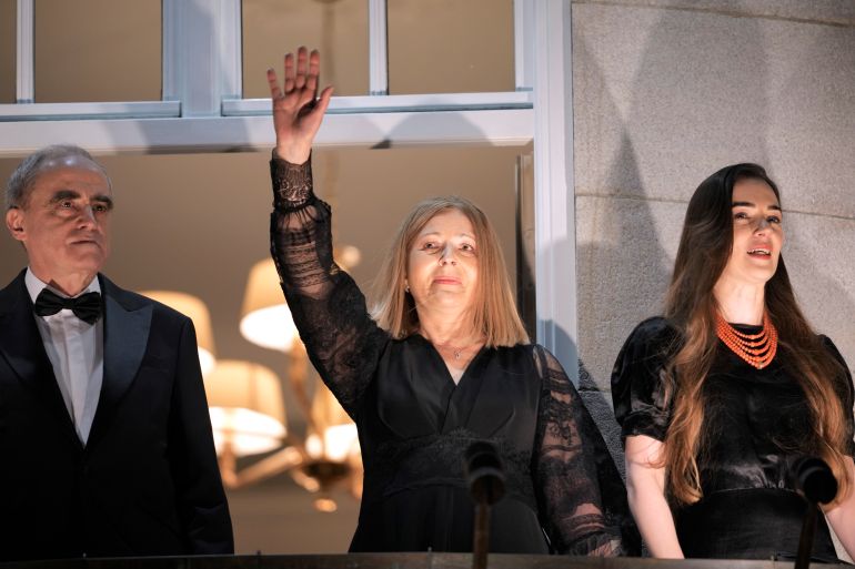 Representatives of the 2022 Nobel Peace Prize laureates Yan Rachinsky, Natalia Pinchuk and Oleksandra Matviychuk waving from a balcony in Oslo, Norway.
