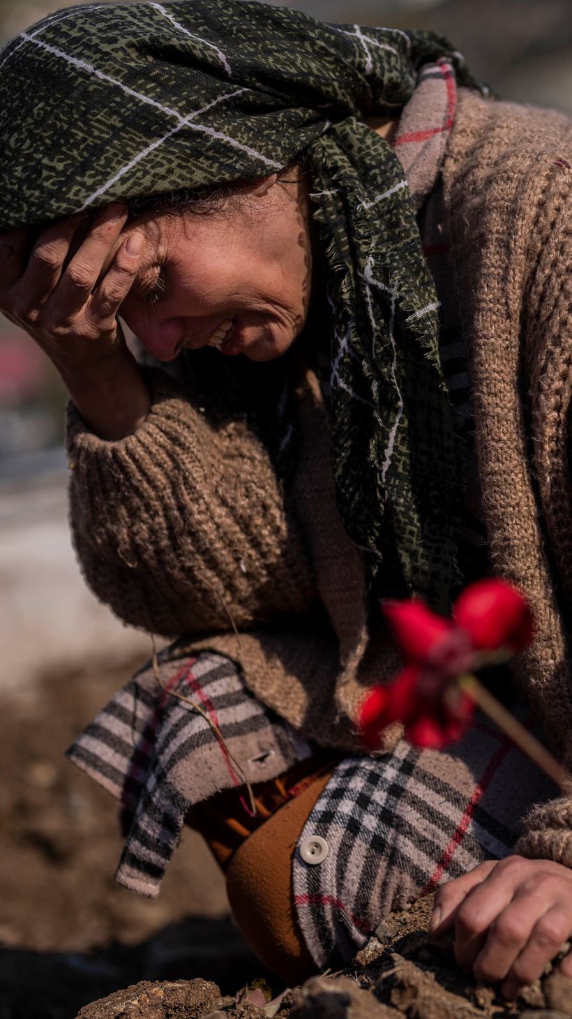 A member of the Vehibe family mourns a relative during the burial of one of the earthquake victims that struck a border region of Turkey and Syria five days ago in Antakya