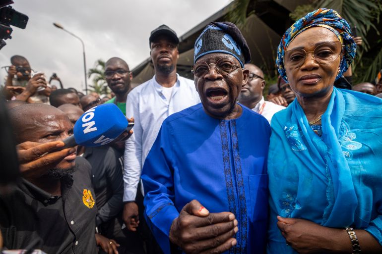 Nigerian President-elect Bola Tinubu. He is with his wife and talking to the media just after voting.