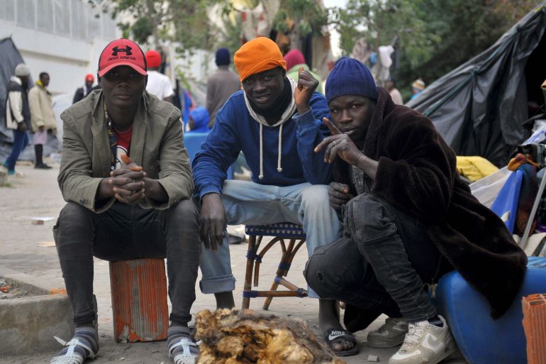Sub-saharan migrants camp outdoors in front of the International Organization for Migration