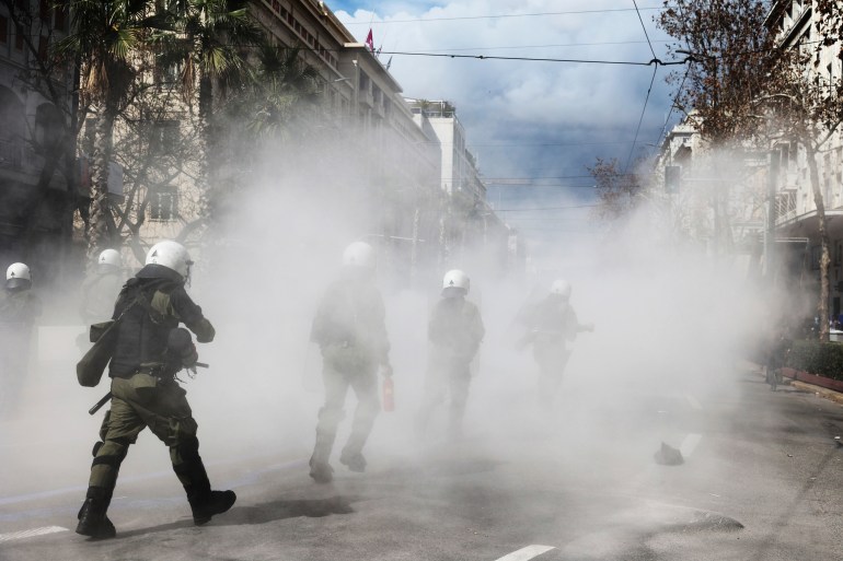 Riot police operate against demonstrators during clashes in Athens, Greece, Sunday, March 5, 2023. 