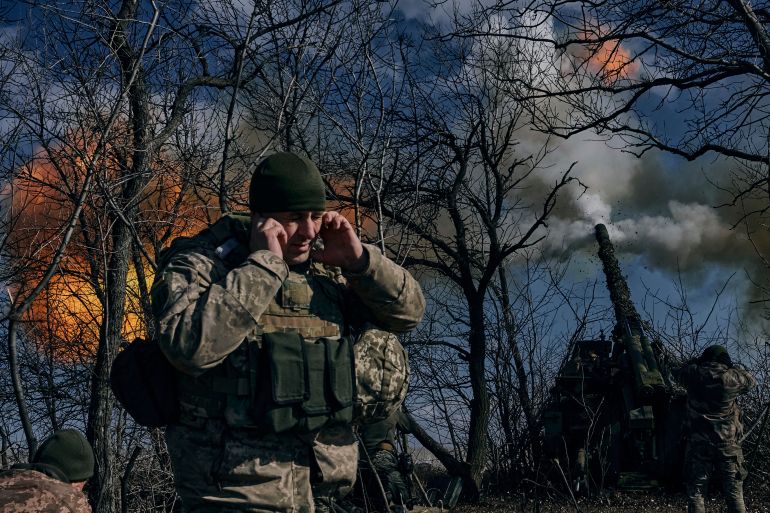 Ukrainian soldiers fire a self-propelled howitzer towards Russian positions near Bakhmut, Donetsk region