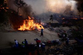 Rohingya refugees try to douse a major fire in their Balukhali camp at Ukhiya in Cox's Bazar district, Bangladesh