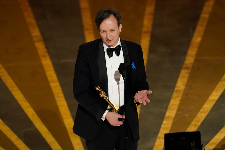 Composer Volker Bertelmann accepts the Oscar for best original score for All Quiet on the Western Front.