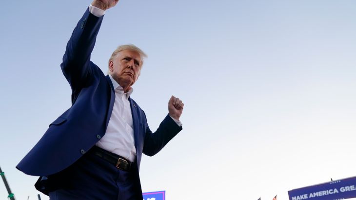 Former President Donald Trump dances with his arms raised during a campaign rally after speaking at Waco Regional Airport.