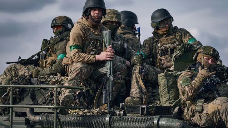 Ukrainian soldiers ride atop an APC on the frontline in Bakhmut, Donetsk region, Ukraine, Sunday, March 26, 2023.
