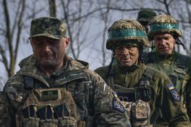 Ukrainian soldiers walk to their position on the frontline near Bakhmut, Donetsk region [Libkos/AP Photo]