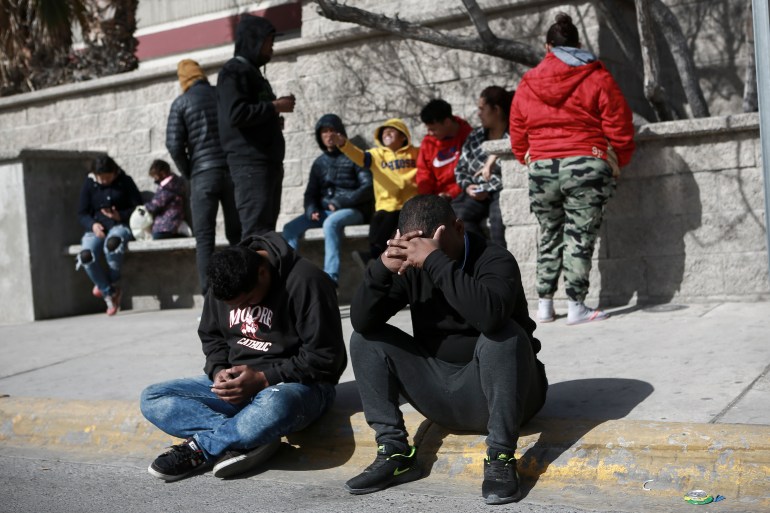 Migrants grieve in front at a Mexican immigration detention center in Ciudad Juarez