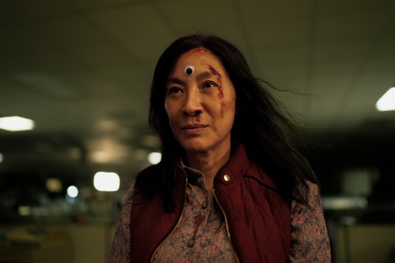 Michelle Yeoh with a googly eye on her forehead in Everything Everywhere All at Once.