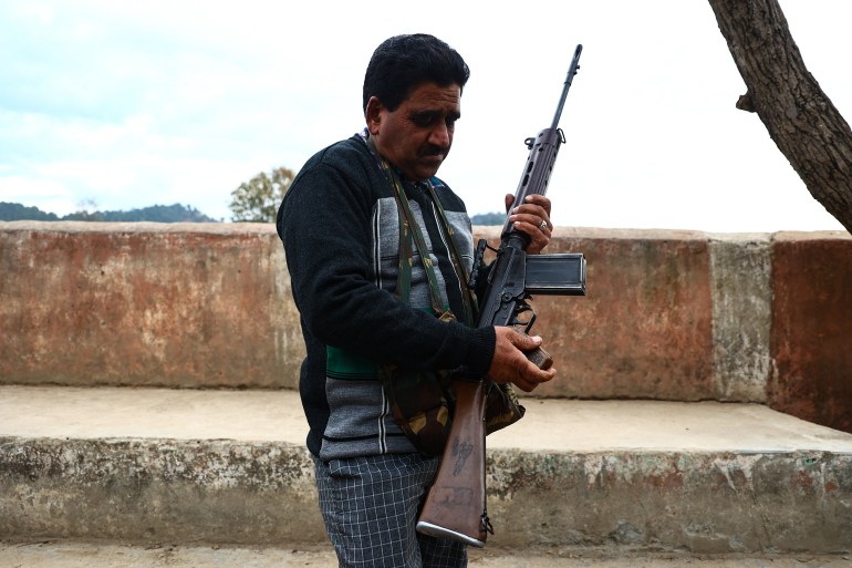 A VDC or Village defence commitee member holds an SLR Rifle after VDC'S are being revamped in Dhangri Village of Rajouri Jammu and Kashmir