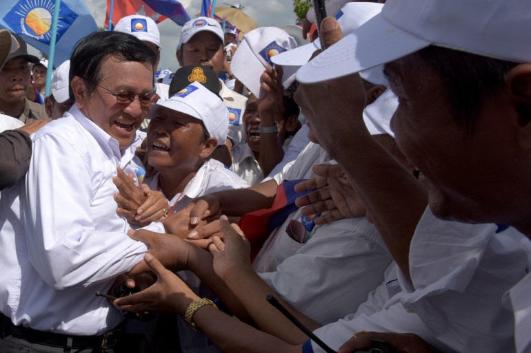 Kem Sokha (L), leader of Cambodia National Rescue Party (CNRP) greets supporters in a rally on the last day of the commune election campaign in Phnom Penh on June 2, 2017. A sea of pro-government supporters rallied in the Cambodian capital in support of strongman PM Hun Sen on June 2, two days before local polls set to test the mettle of an opposition desperate to upend his 32-year rule.