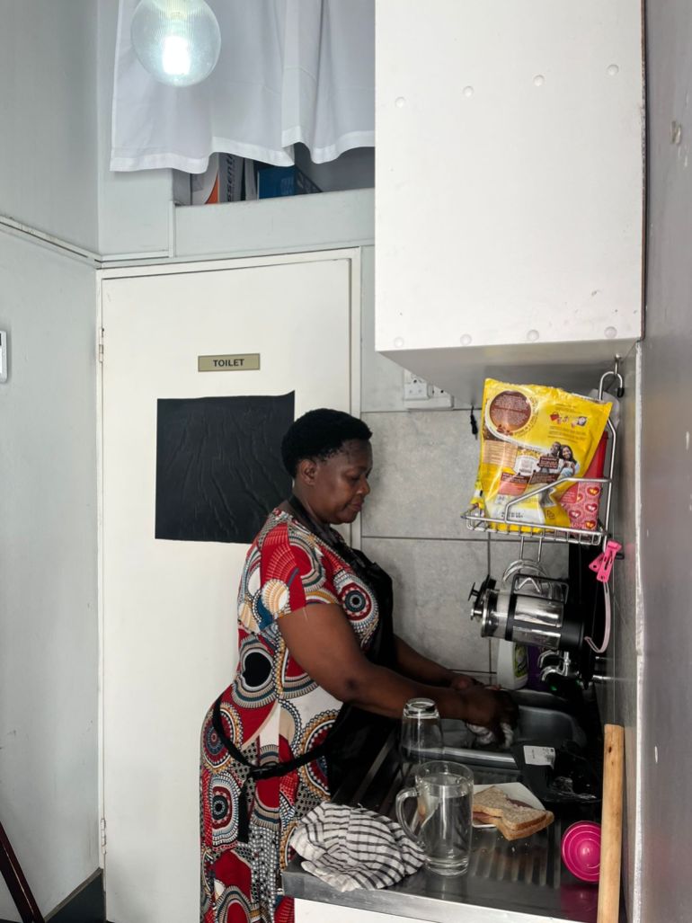 A photo of Mavis Namba using an coffee machine.