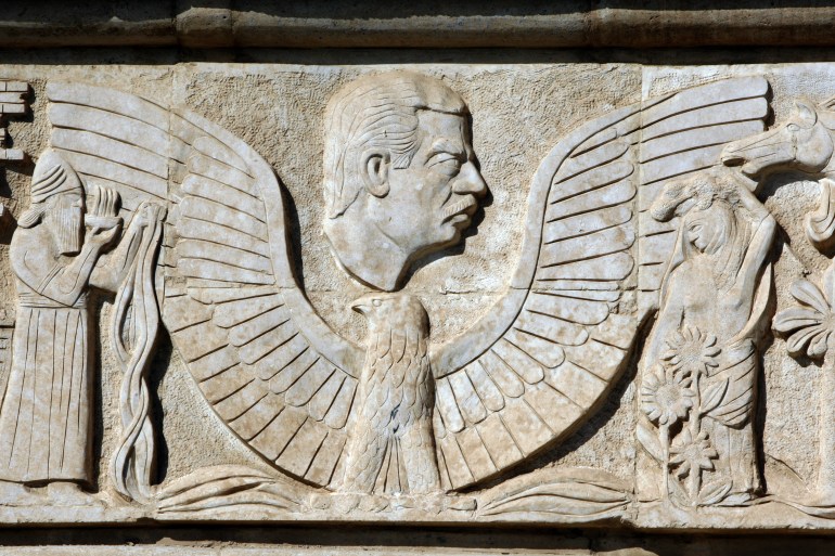 Brutalist stone relief work depicts the profile of the late Iraqi leader Saddam Hussein