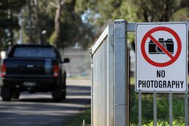 A metal fence and a sign saying 'no photography' outside the Villawood immigration detention centre in Sydney