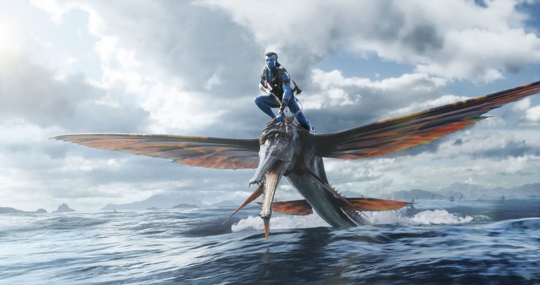 Jake Sully (Sam Worthington) riding an flying animal in 20th Century Studios' AVATAR: THE WAY OF WATER