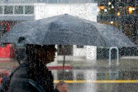 A person uses an umbrella to avoid the rain in California