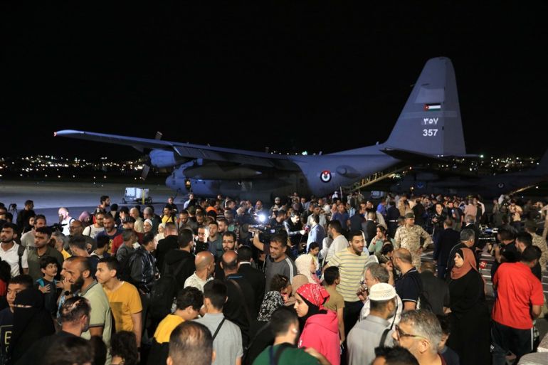 A group of 343 citizens of Jordan, Palestine, Iraq, Syria, and Germany evacuated from Sudan disembarks from a military aircraft at Marka Military Airport, in Amman, Jordan