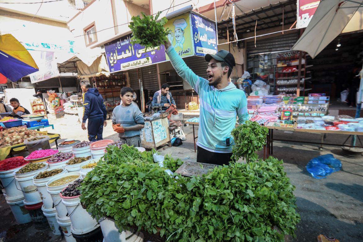 Khalil Al-Shaer, 25, from Rafah, south of the Gaza Strip, sells vegetables including Rocca in the Rafah central market.