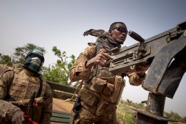 Soldiers of the Malian army manning a machine gun during a patrol on the road between Mopti and Djenne, in central Mali, on February 28, 2020.