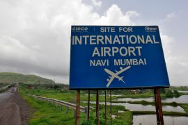 A signboard at the proposed site of the Navi Mumbai airport, about 45km (27 miles) east of Mumbai, India.