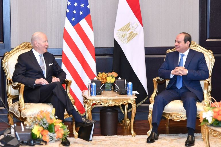 Joe Biden sits across from Abdel Fattah el-Sisi with American and Egyptian flags in the background