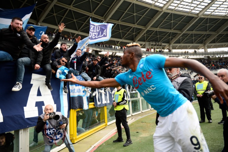 Osimhen celebrates with Napoli fans after a match