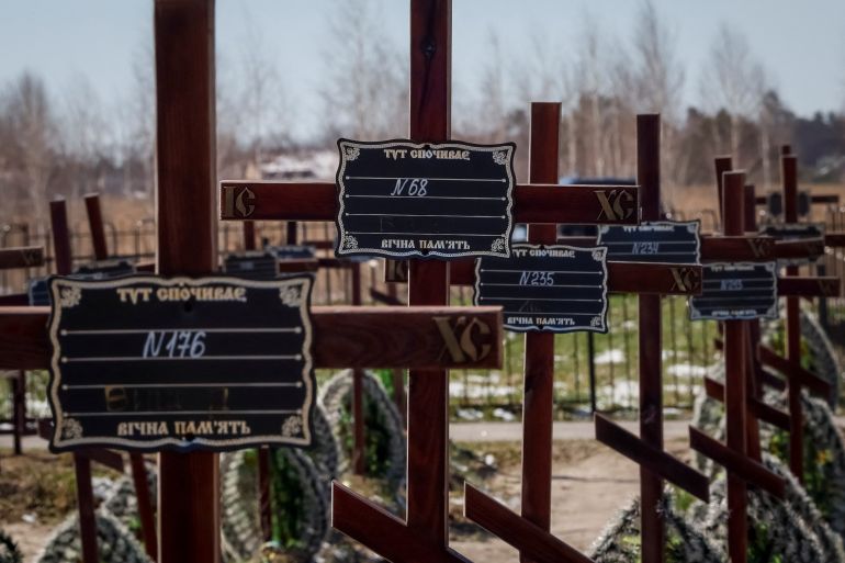 Graves of unidentified people killed by Russian soldiers during occupation of the Bucha town, are seen at the town's cemetery, before the first anniversary of its liberation, amid Russia's attack on Ukraine, in the town of Bucha, outside Kyiv, Ukraine March 30, 2023. REUTERS/Gleb Garanich