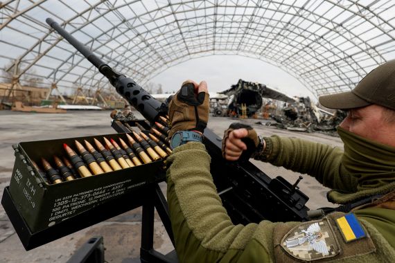 A member of the mobile air defence group checks a M2 Browning machine gun in the town of Hostomel, Kyiv region