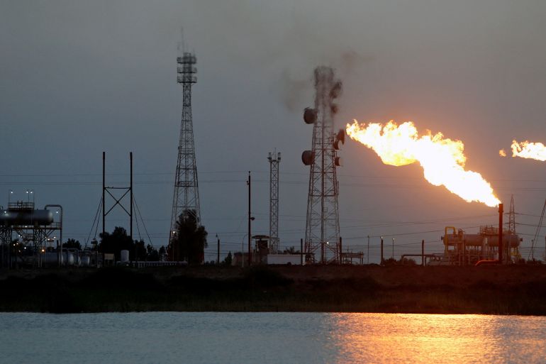 FILE PHOTO: Flames emerge from flare stacks at Nahr Bin Umar oil field, north of Basra, Iraq March 9, 2020. REUTERS/Essam Al-Sudani/File Photo