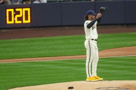 The MLB pitch clock is seen as Milwaukee Brewers starting pitcher Freddy Peralta stands on the mound