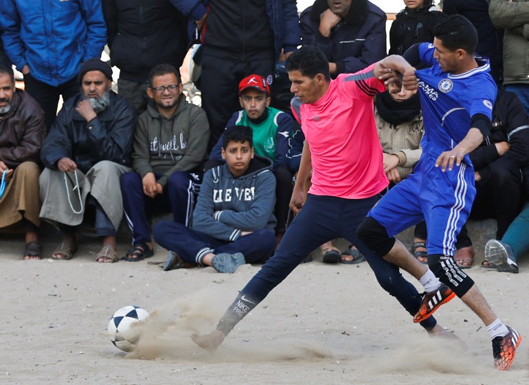 Young Palestinian men play football
